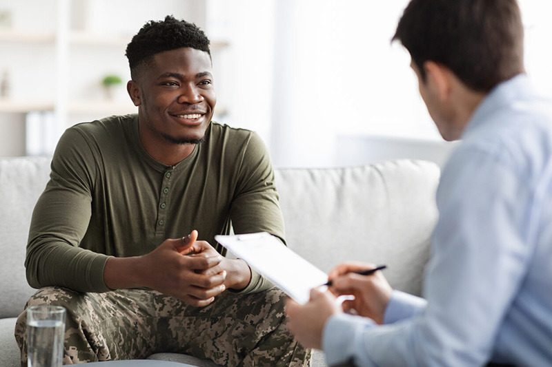 young man speaking to mental health professional