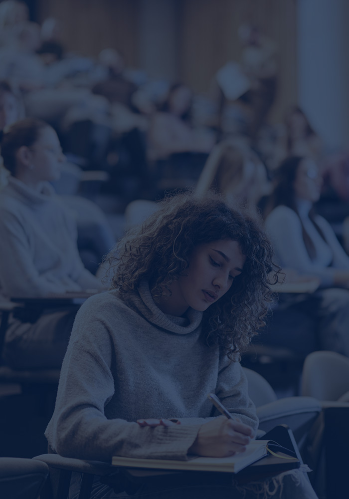 student takes notes in class