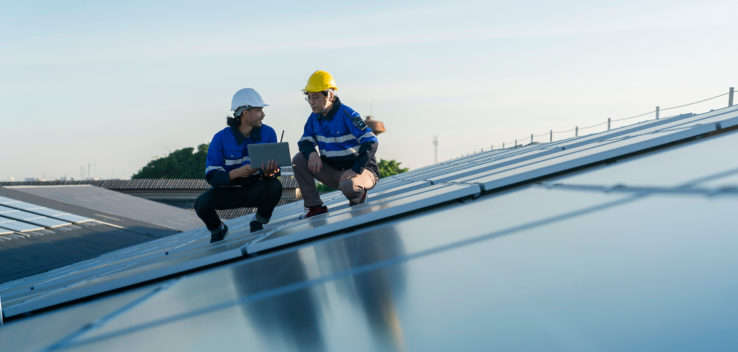 two technicians survey solar installation