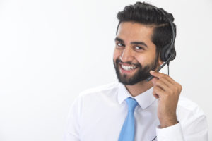 smiling man provides technical support over the phone